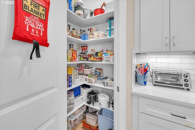 kitchen with appliances with stainless steel finishes, a sink, white cabinetry, light countertops, and recessed lighting