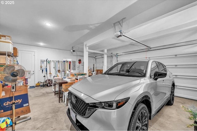 garage with a garage door opener and recessed lighting