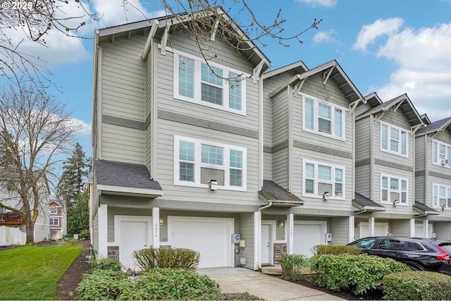 multi unit property featuring an attached garage and driveway