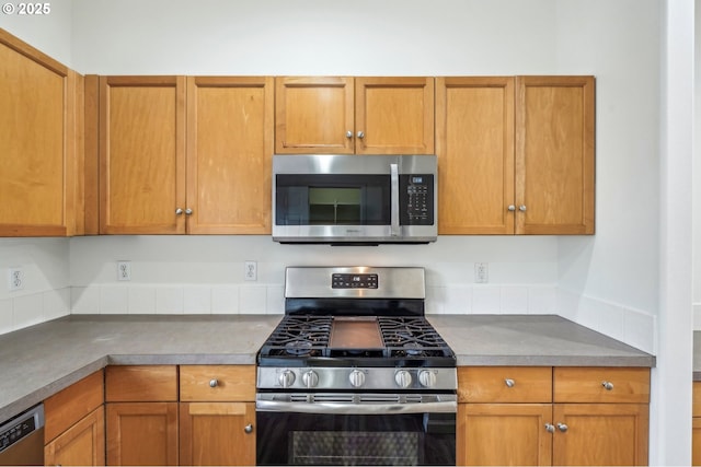kitchen featuring stainless steel appliances and brown cabinets
