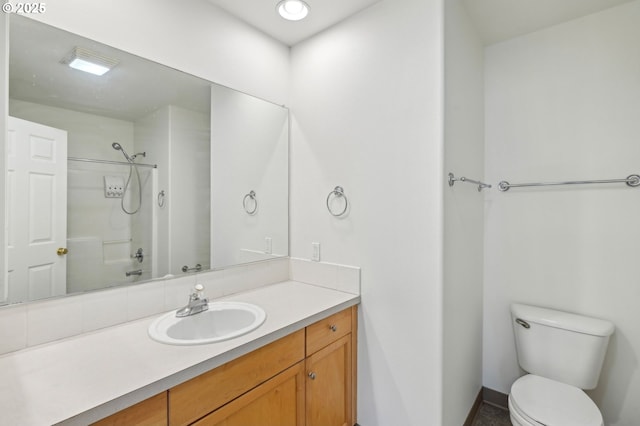 full bathroom with vanity, baseboards, a shower, and toilet