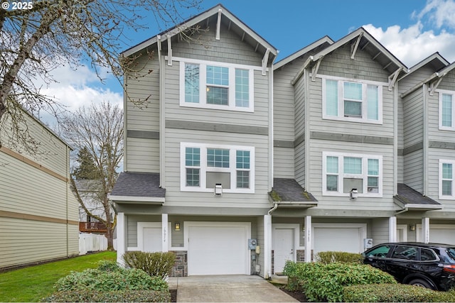 townhome / multi-family property with concrete driveway and an attached garage
