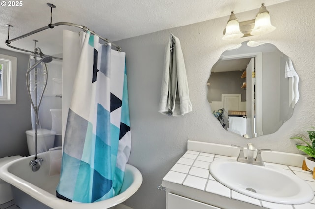 full bathroom with a textured wall, a shower with curtain, a tub to relax in, vanity, and a textured ceiling