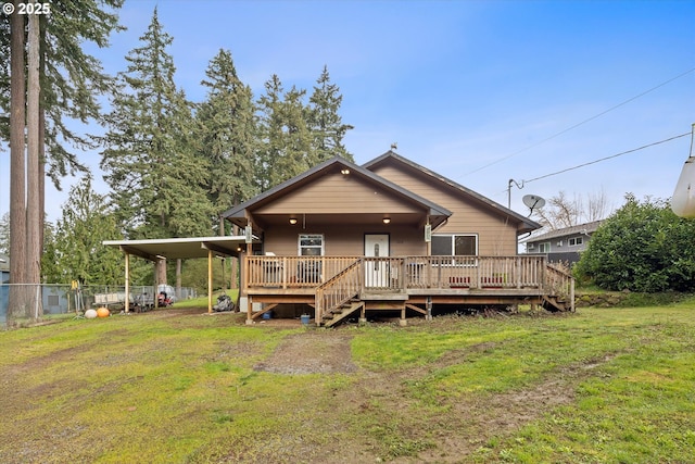 rear view of property with driveway, an attached carport, a yard, fence, and a wooden deck