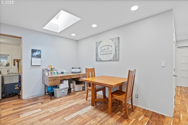 dining area featuring recessed lighting, a skylight, and wood finished floors