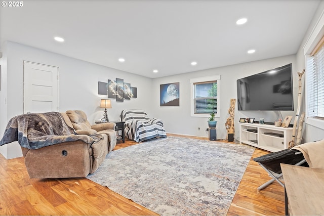 living area with recessed lighting and wood finished floors