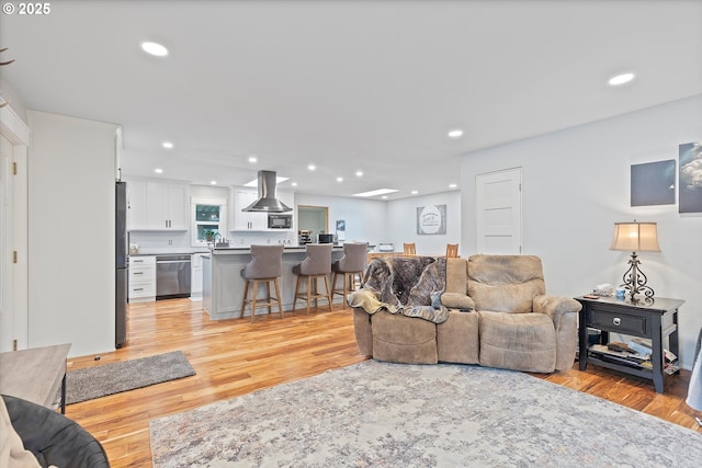 living area featuring light wood-style floors and recessed lighting