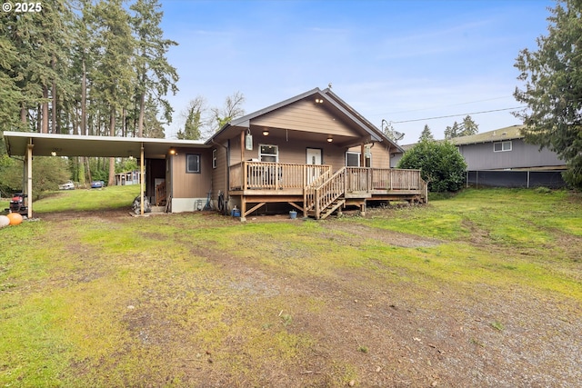 view of front of property featuring a deck, driveway, an attached carport, and a front yard