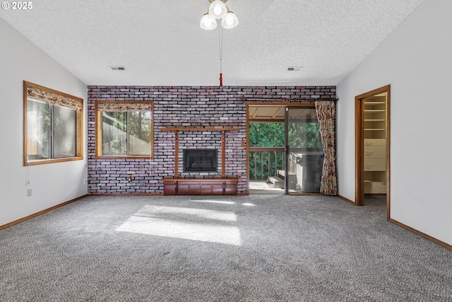 17002 NE 50th Ave, Vancouver, WA 98686 - unfurnished living room with a textured ceiling, carpet flooring, baseboards, a brick fireplace, and brick wall