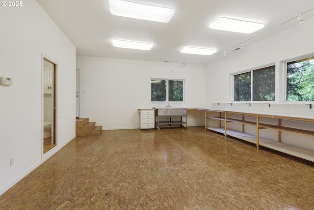 17002 NE 50th Ave, Vancouver, WA 98686 - spare room featuring track lighting, stairway, baseboards, and a sink