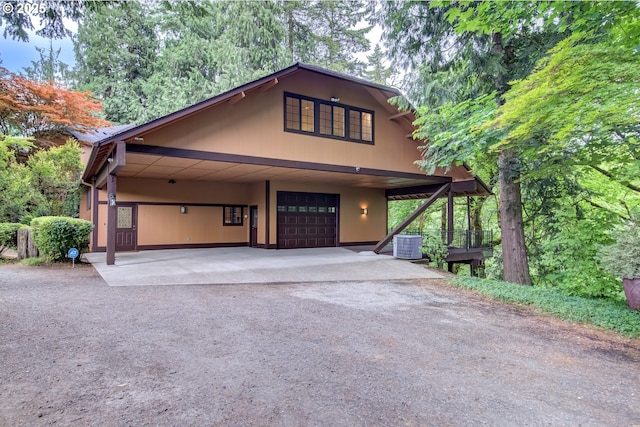 17002 NE 50th Ave, Vancouver, WA 98686 - rustic home featuring dirt driveway, central AC unit, an attached garage, and an attached carport