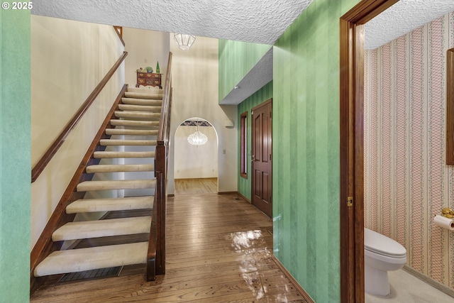 17002 NE 50th Ave, Vancouver, WA 98686 - stairway with wood-type flooring, wallpapered walls, a textured ceiling, and baseboards