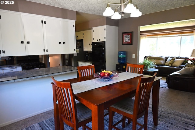 7811 NE 78th St, Vancouver, WA 98662 - dining space featuring dark carpet, a notable chandelier, and a textured ceiling