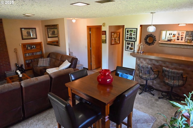 7811 NE 78th St, Vancouver, WA 98662 - carpeted dining area with a bar, a textured ceiling, and visible vents