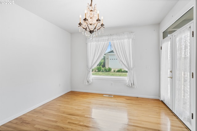 301 Chinook St, Molalla, OR 97038 - unfurnished bedroom featuring a chandelier, wood finished floors, and baseboards