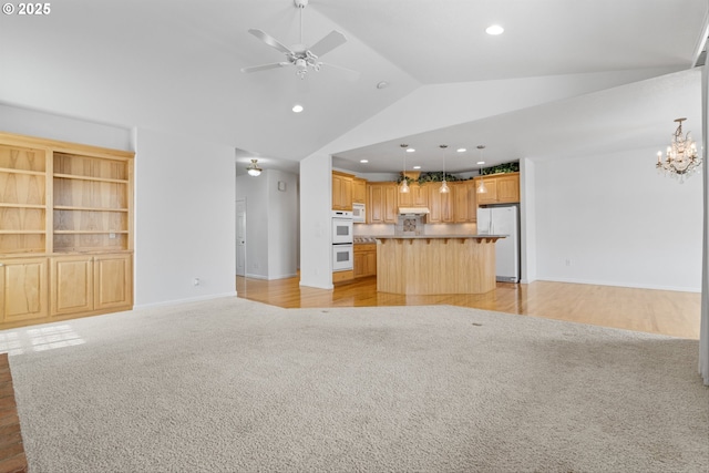 301 Chinook St, Molalla, OR 97038 - unfurnished living room featuring light colored carpet, vaulted ceiling, a ceiling fan, baseboards, and recessed lighting
