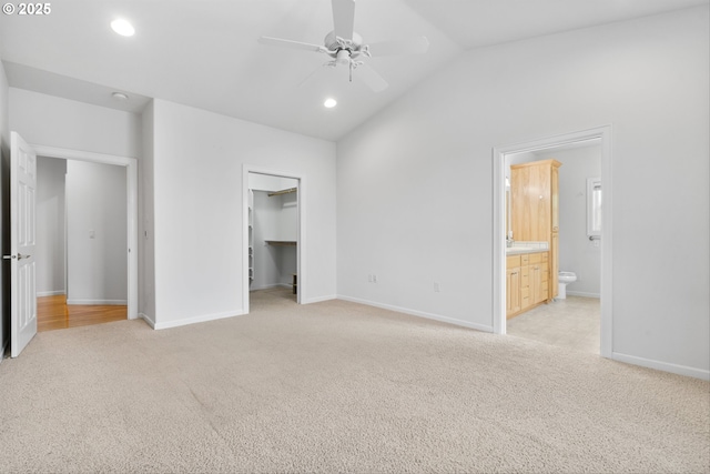 301 Chinook St, Molalla, OR 97038 - unfurnished bedroom featuring light colored carpet, vaulted ceiling, baseboards, recessed lighting, and a walk in closet