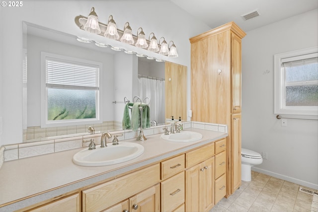 301 Chinook St, Molalla, OR 97038 - bathroom featuring toilet, double vanity, healthy amount of natural light, and tile patterned flooring