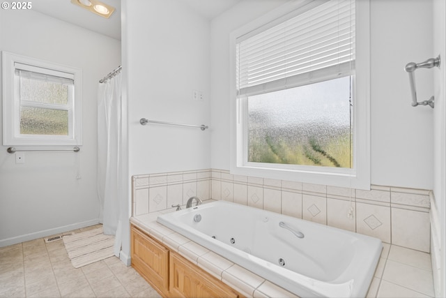 301 Chinook St, Molalla, OR 97038 - bathroom with healthy amount of natural light, a jetted tub, a shower with shower curtain, and tile patterned flooring