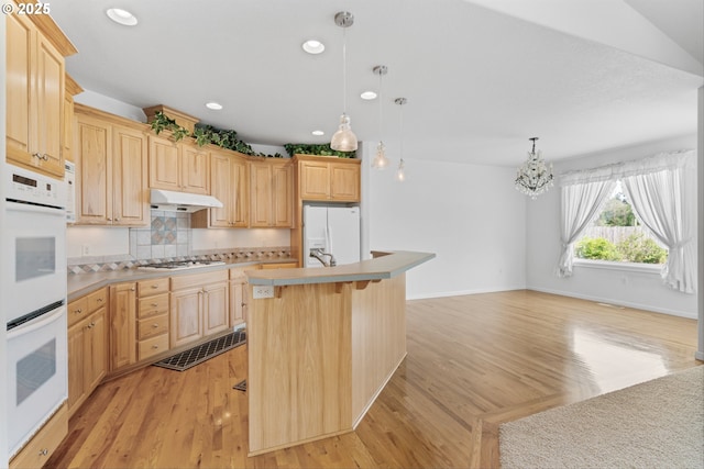 301 Chinook St, Molalla, OR 97038 - kitchen featuring white appliances, light brown cabinets, a kitchen breakfast bar, light countertops, and tasteful backsplash