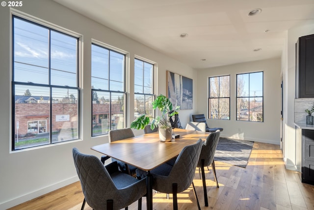 dining room with a healthy amount of sunlight, light wood-style flooring, baseboards, and recessed lighting