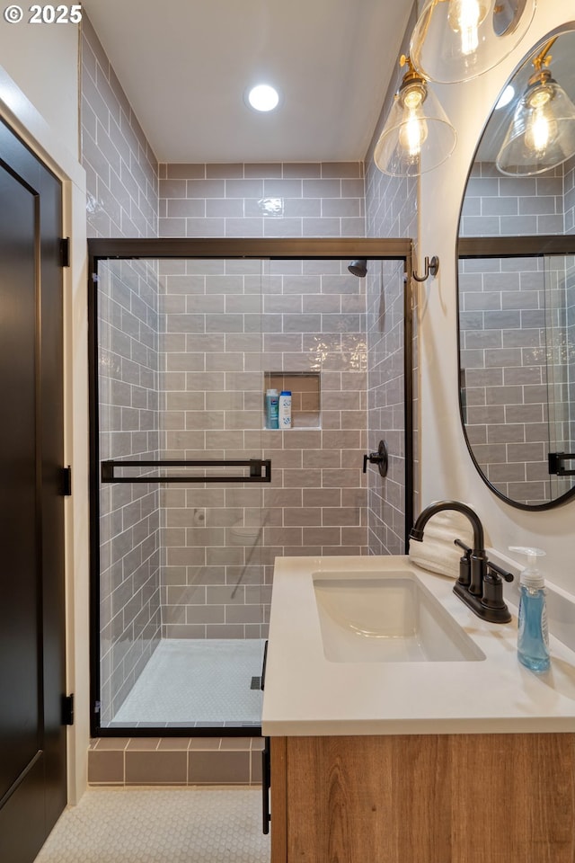 full bathroom featuring tile patterned flooring, a shower stall, and vanity