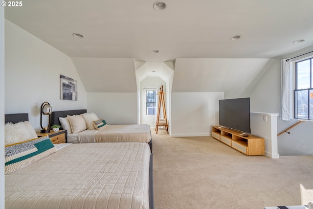 bedroom featuring vaulted ceiling, baseboards, and light colored carpet