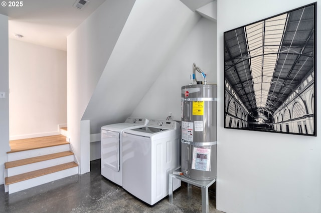 laundry area featuring laundry area, visible vents, baseboards, strapped water heater, and washer and dryer