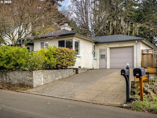 ranch-style home with an attached garage, a shingled roof, driveway, crawl space, and a chimney