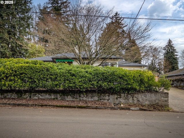 view of property hidden behind natural elements