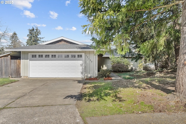 view of front of house featuring driveway, board and batten siding, and an attached garage