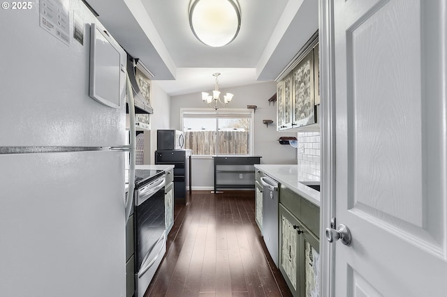 kitchen featuring a notable chandelier, dark wood-style floors, appliances with stainless steel finishes, light countertops, and hanging light fixtures