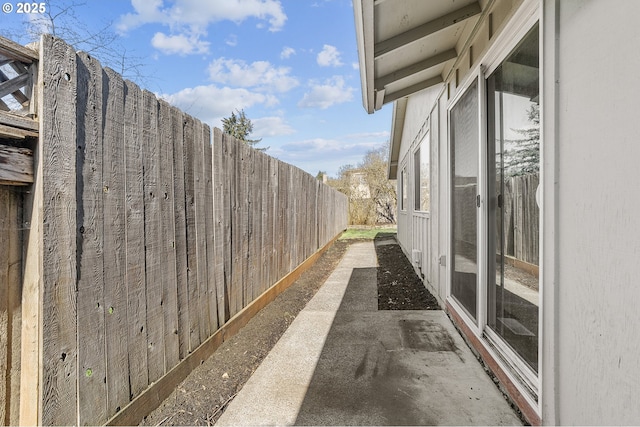 view of home's exterior with a patio area and a fenced backyard