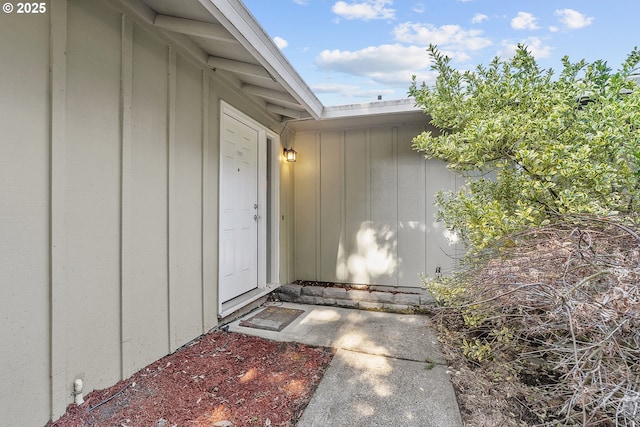 view of exterior entry with board and batten siding