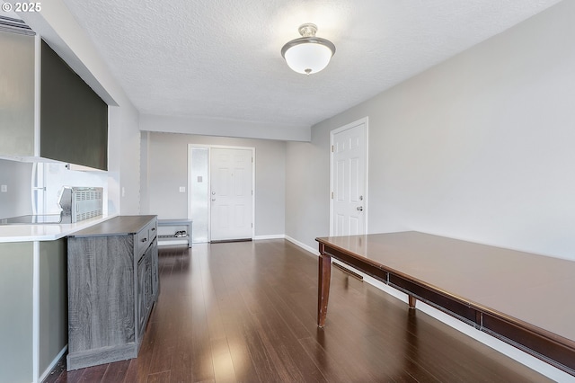 kitchen featuring a textured ceiling, modern cabinets, baseboards, and dark wood-style flooring