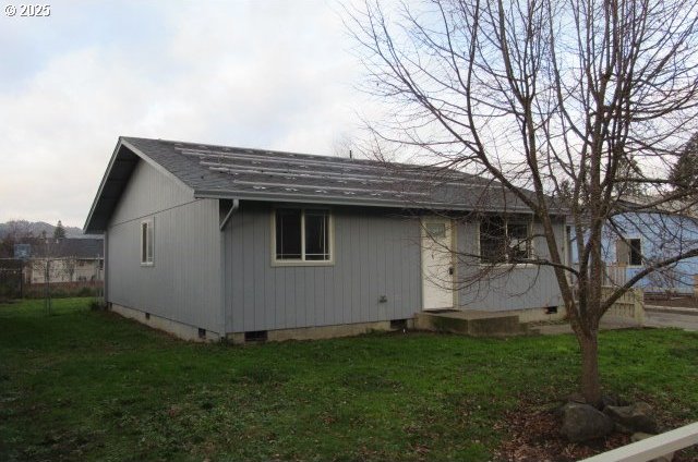 view of side of home featuring a lawn