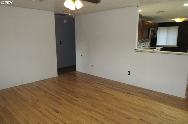 spare room featuring ceiling fan and light hardwood / wood-style flooring