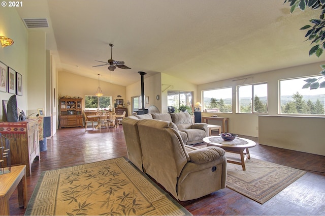 living area with ceiling fan, visible vents, lofted ceiling, and dark wood finished floors