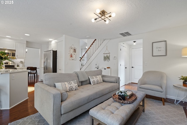 living room featuring dark hardwood / wood-style floors and a textured ceiling