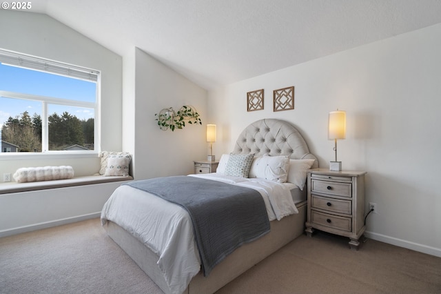 bedroom with vaulted ceiling and carpet floors