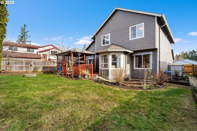 rear view of property with a yard and a gazebo