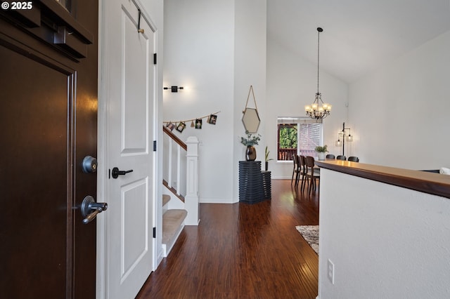 entryway featuring high vaulted ceiling, a chandelier, and dark hardwood / wood-style flooring