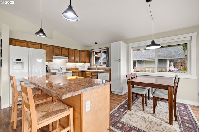 kitchen featuring light wood-style floors, white appliances, a sink, and under cabinet range hood