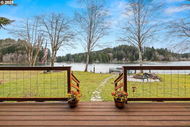 deck featuring a yard, a dock, and a water view