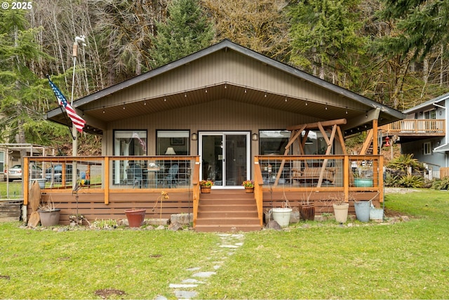 back of property with a lawn and a wooden deck