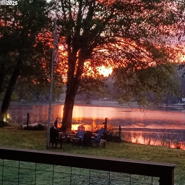 view of yard with an outdoor fire pit and a water view