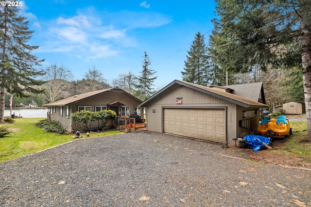 view of front of home featuring a front lawn, driveway, and an attached garage