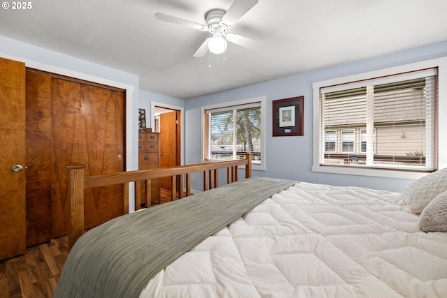 bedroom featuring a ceiling fan, a closet, and wood finished floors