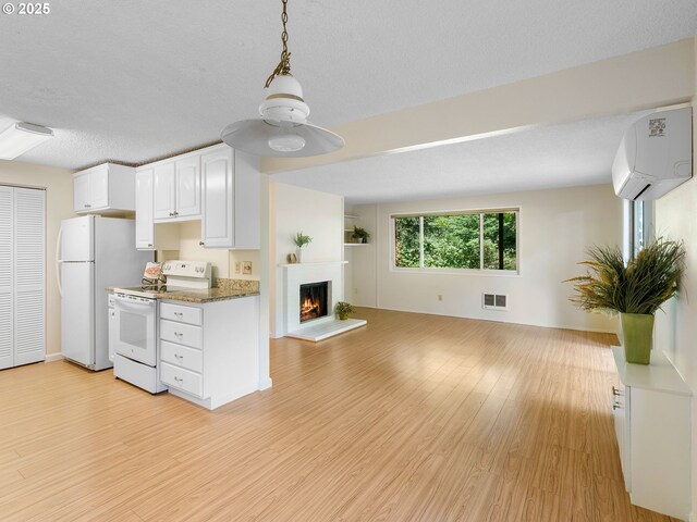 7116 SW Murray Blvd, Beaverton, OR 97008 - kitchen featuring white appliances, an AC wall unit, open floor plan, and light wood-style floors