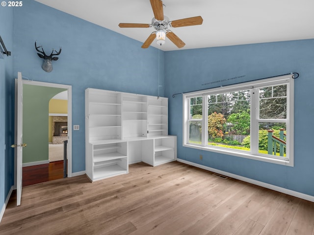 343 Hemlock St, Seaside, OR 97138 - unfurnished bedroom with baseboards, a brick fireplace, visible vents, and wood finished floors